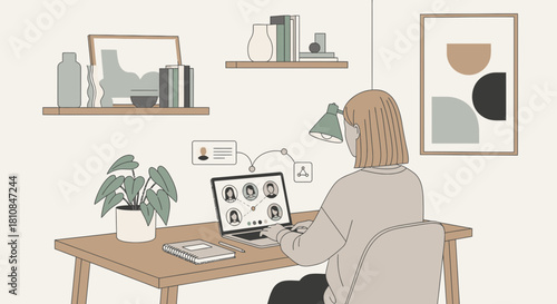 Woman attending an online meeting on her laptop computer, diligently working from a well-organized desk.