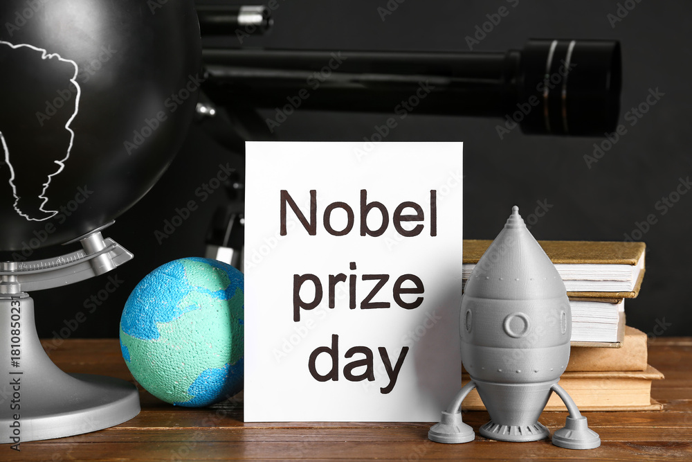 Fototapeta premium Paper with text NOBEL PRIZE DAY, globe, rocket and earth model on tile against grey background