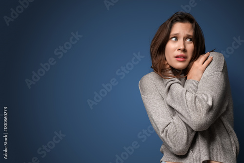 Scared young woman on dark ...