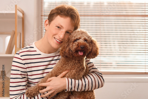 Young man with cute Toy Poo...