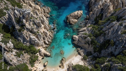 High-angle view of a secluded cove with turquoise water and light gray rocks.