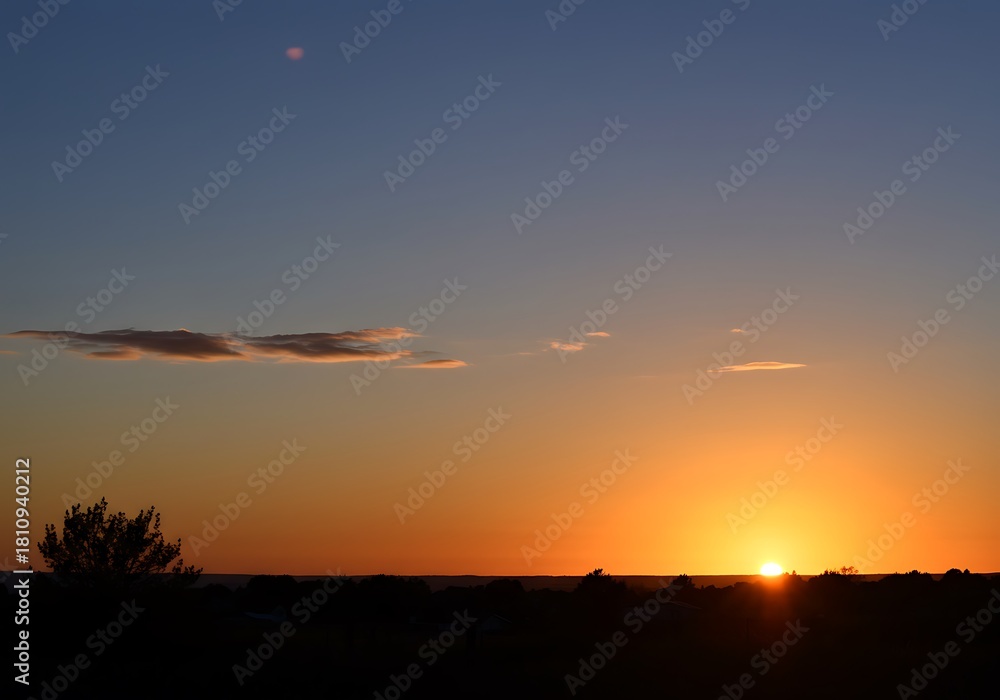 Fototapeta premium Vibrant sunset landscape silhouette with dramatic sky and horizon