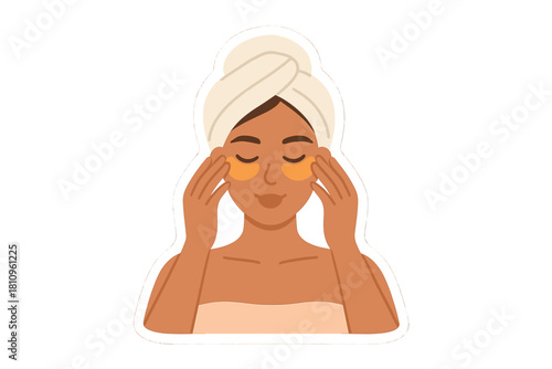 Woman applying under eye patches while relaxing with hair wrapped in towel