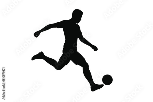 Soccer player silhouette kicking ball during competitive sports match action