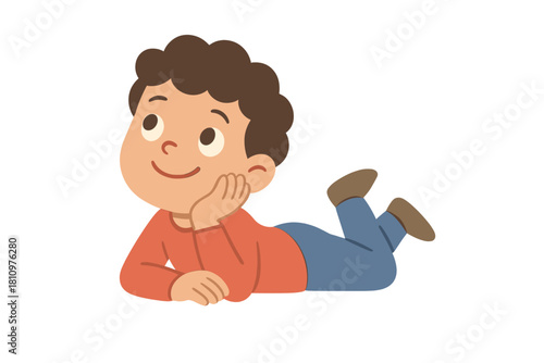 Cheerful young boy resting on stomach looking up thoughtfully