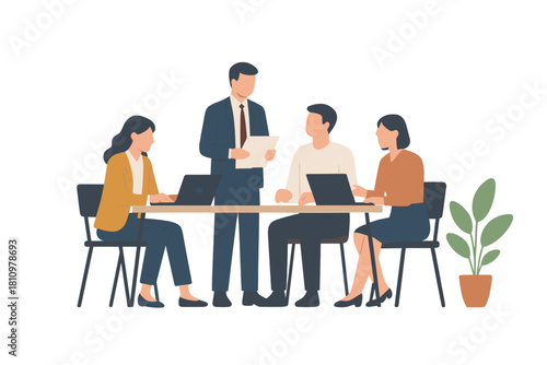 Business team meeting with laptops around conference table