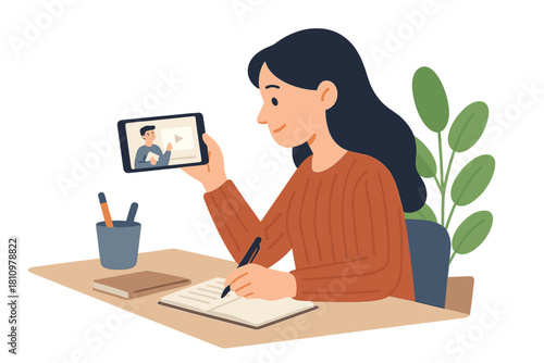 Young woman watches online lecture on tablet while taking notes