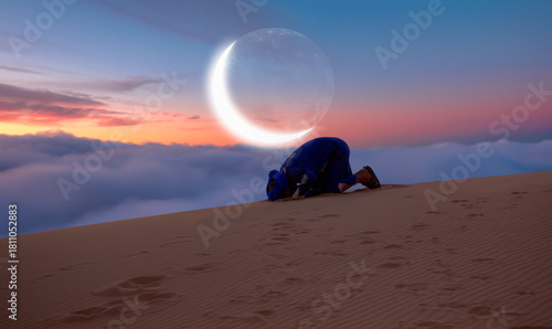 Fototapeta Naklejka Na Ścianę i Meble -  A man praying in the desert with a crescent moon in the background