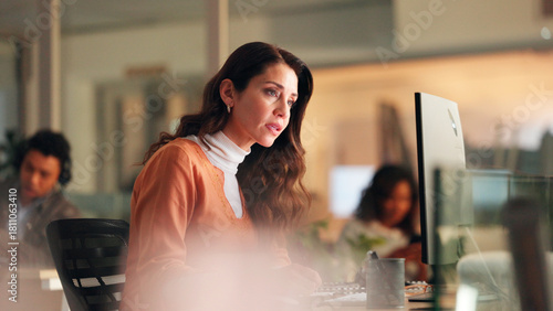 Night, woman or worry with computer in office for journalism ethics fail, bad review or problem. Late, concerned writer or coworking with pc for plagiarism report, fake news issue or reputation risk.