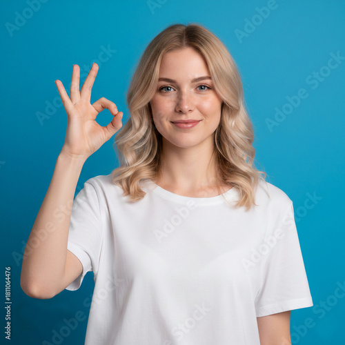 A young woman creating an ok sign with her hand.