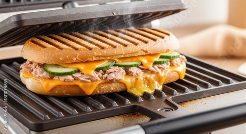 Melting cheese and tasty sandwich grilling on panini press for a quick meal