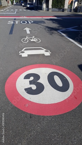 Road sign speed limit 30 km/h, road sign for cars and bicycles at STOP, Italy.