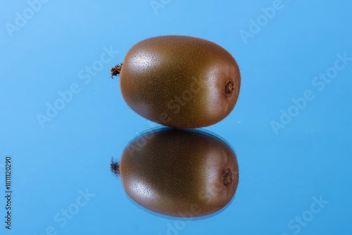 Kiwi Fruit on Mirror Surface Reflecting Natural Perfection