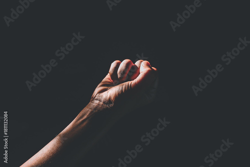 man's hand with light in the dark