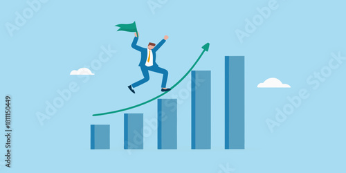 Businessman celebrating success on a rising chart with a flag in hand