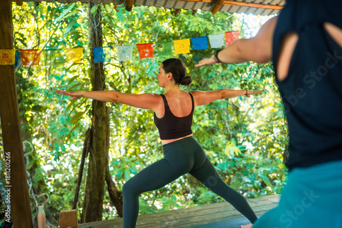 Woman practicing warrior pose during yoga session