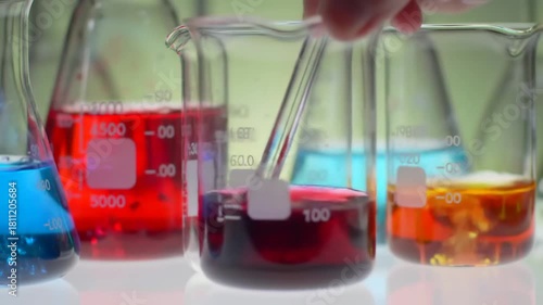 Laboratory glassware with colored liquids in scientific experiment, in an academic setting, for research