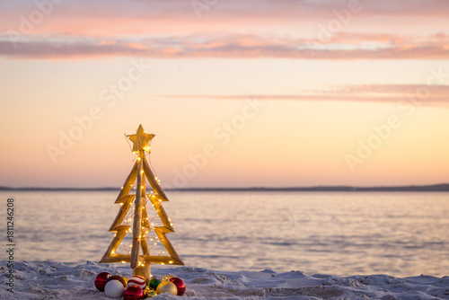 Simple rustic Christmas tree on a sandy idyllic beach