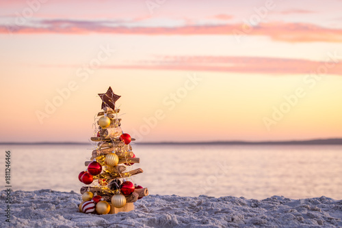 Driftwood Christmas tree adorned with a star, baubles and fairy lights