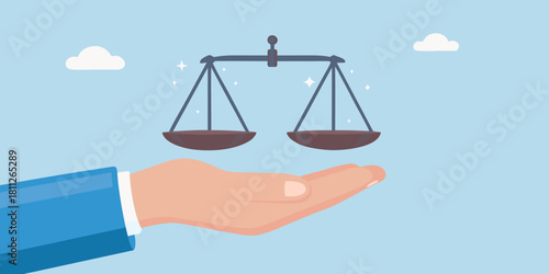 Hand holding scales of justice symbolizing law balance and fairness
