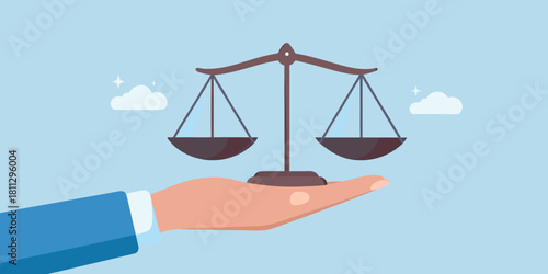 Hand holding scales of justice symbol of fairness and legal balance