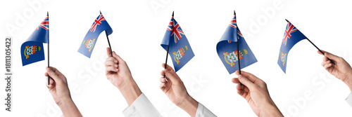 The Cayman Islands flag in hand in different angles on a white background