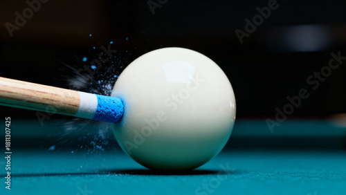Close-up of a Pool Ball Being Struck by a Cue Stick on a Green Felt Table