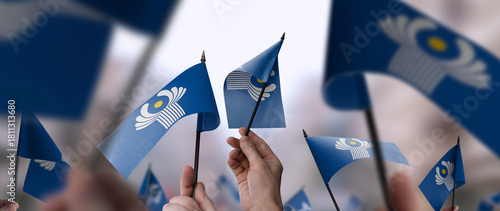 CIS flags in their hands on a blurred urban background