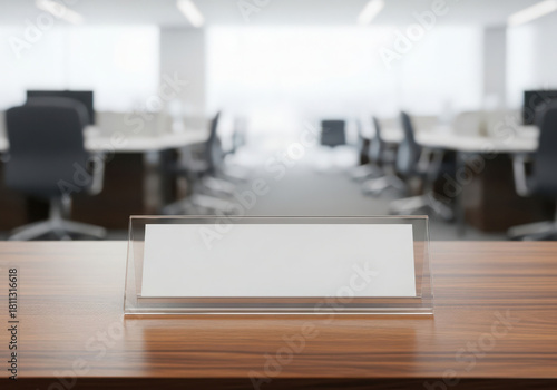 Blank nameplate on a wooden desk in a modern office setting