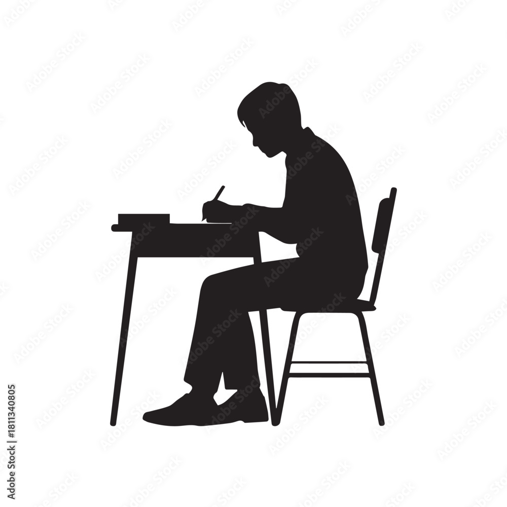 Fototapeta premium Silhouette of a student writing at a desk