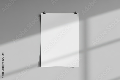 White paper poster mockup hanging on clips against wall background