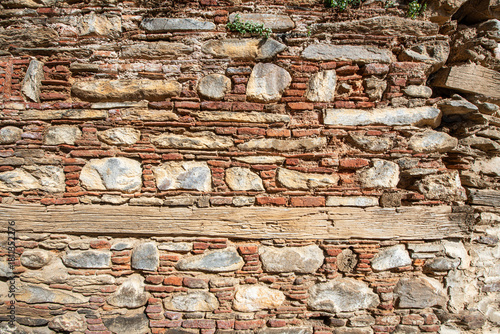 Stone walls of historical buildings. Stone walls of old wooden buildings. Stone-built architecture. Stone walls of historical Birgi houses in the Ödemiş district. Türkiye.