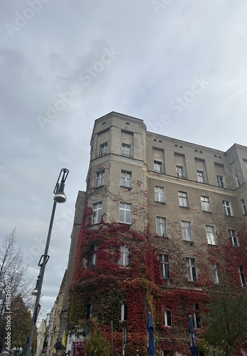 Berlin Germany October 2025 Tall corner building with autumn ivy under gray sky