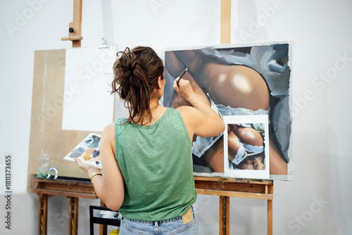 Artist painting a realistic body artwork in an art studio