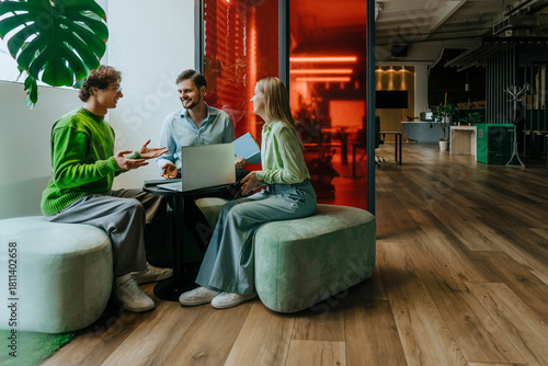 Colleagues discussing a business project at a modern office meeting