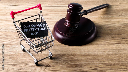 Consumer Protection Act concept with a judge's gavel and a miniature shopping cart, symbolizing buyer rights and legal regulation in commerce.
