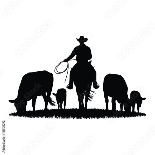 Silhouette of a cowboy on horseback herding cattle in a field