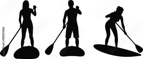 Silhouettes of three people paddleboarding on water in active outdoor sport exercise