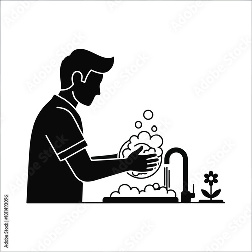 Silhouette of a person washing dishes in a sink with soapy water and bubbles.