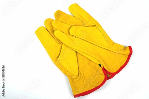 one pair of yellow leather gloves on a white background 