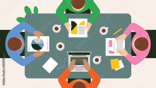 top-down view of diverse team collaborating around table with laptop, charts, coffee cups, and documents in office setting