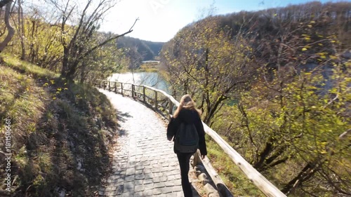 Woman hiking Plitvicka Jezera Croatia travel destination scenic lakes waterfalls nature park landscape outdoor adventure tourism national park Unesco heritage