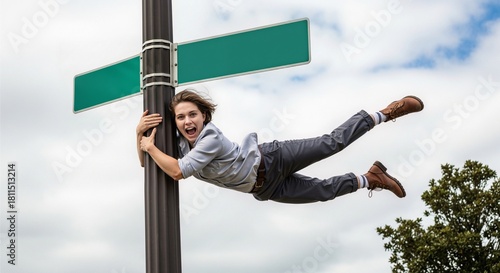 Windblown Daredevil: Woman Clinging to Blank Sign in Powerful Gust
