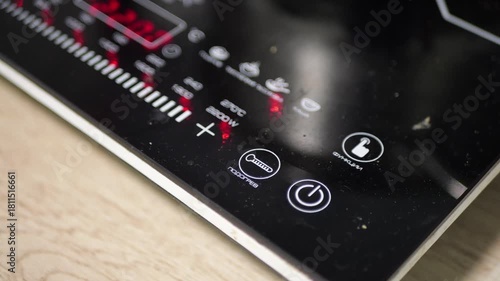 Black Glossy Induction Cooktop Turning on in Modern Kitchen with Electronic Beep Sound and Fan Whirring Noise Technology Home Appliance Efficiency Concept Detailed Close up Visual