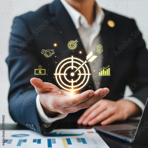 Corporate professional presenting marketing target hologram above open hand with sales, growth and money icons — business strategy, lead generation and customer engagement concept