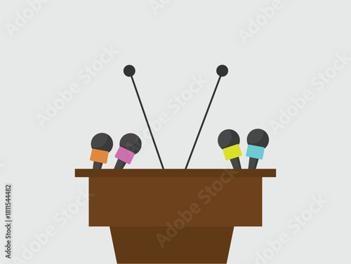 Podium with multiple colorful microphones, representing a press conference, speech, or public announcement.