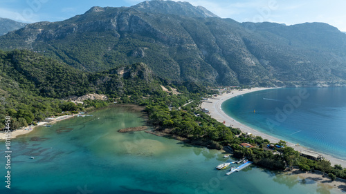 Fototapeta Naklejka Na Ścianę i Meble -  Aerial view of Ölüdeniz Blue Lagoon showing its iconic turquoise waters and summer coastline