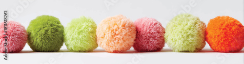 Colorful fluffy pom poms in a row creative and playful display