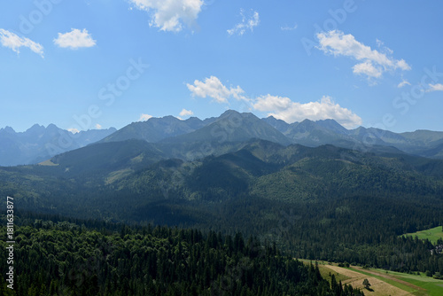 Fototapeta Naklejka Na Ścianę i Meble -  High Tatras seen from a metal observation tower with a modern glass terrace offering a stunning panorama at Poronin, Poland. Majestic mountains peaks of High Tatra moutnains.