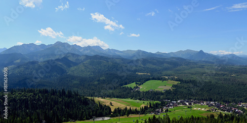 Fototapeta Naklejka Na Ścianę i Meble -  Majestic mountains peaks of High Tatra moutnains. High Tatras and Male Ciche ski resort seen from a metal observation tower with a modern glass terrace offering a stunning panorama at Poronin, Poland